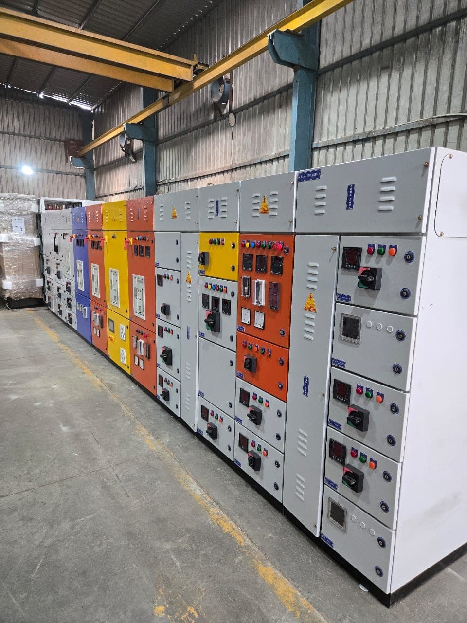 Long panel line-up with colour-coded incomer sections