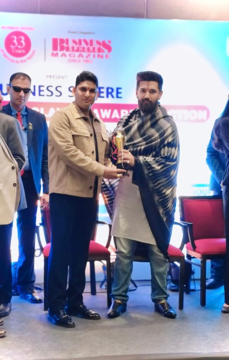 Director Pramod Kumar receiving the business excellence award trophy from Cabinet Minister Chirag Paswan